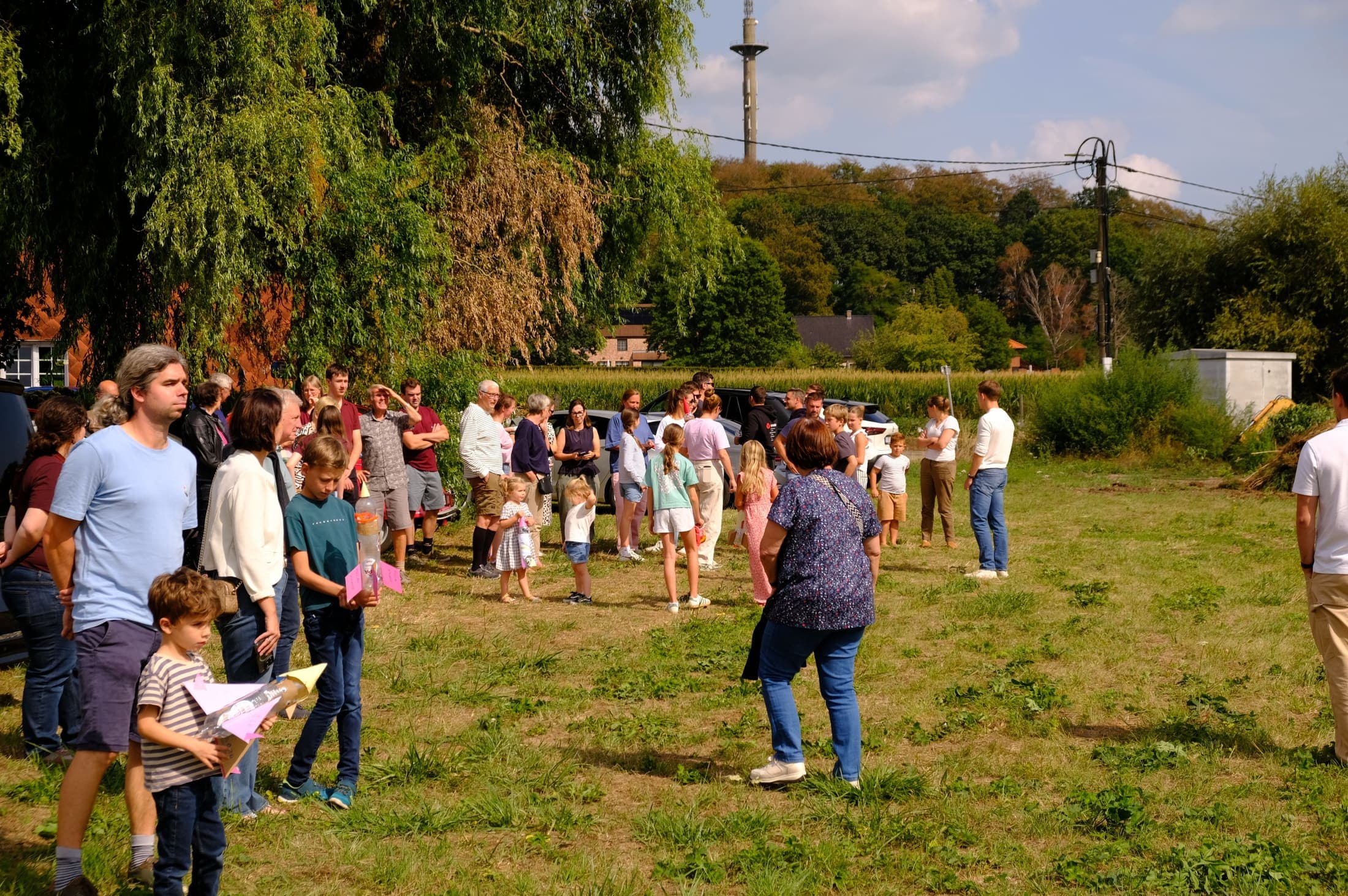 A water rocket streaks skyward over the launch field as the crowd watches.