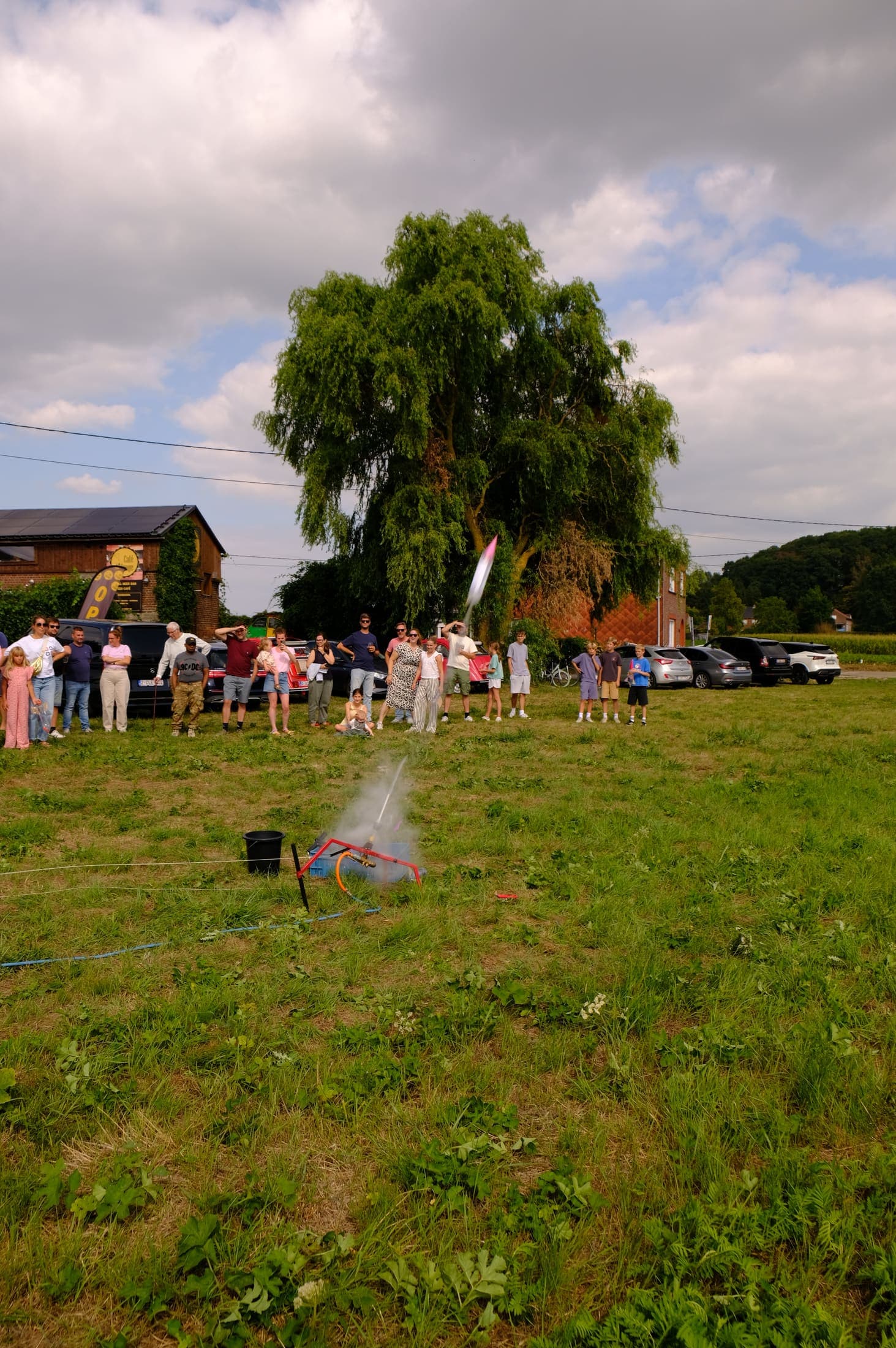 Families gathered on the field watching a launch.