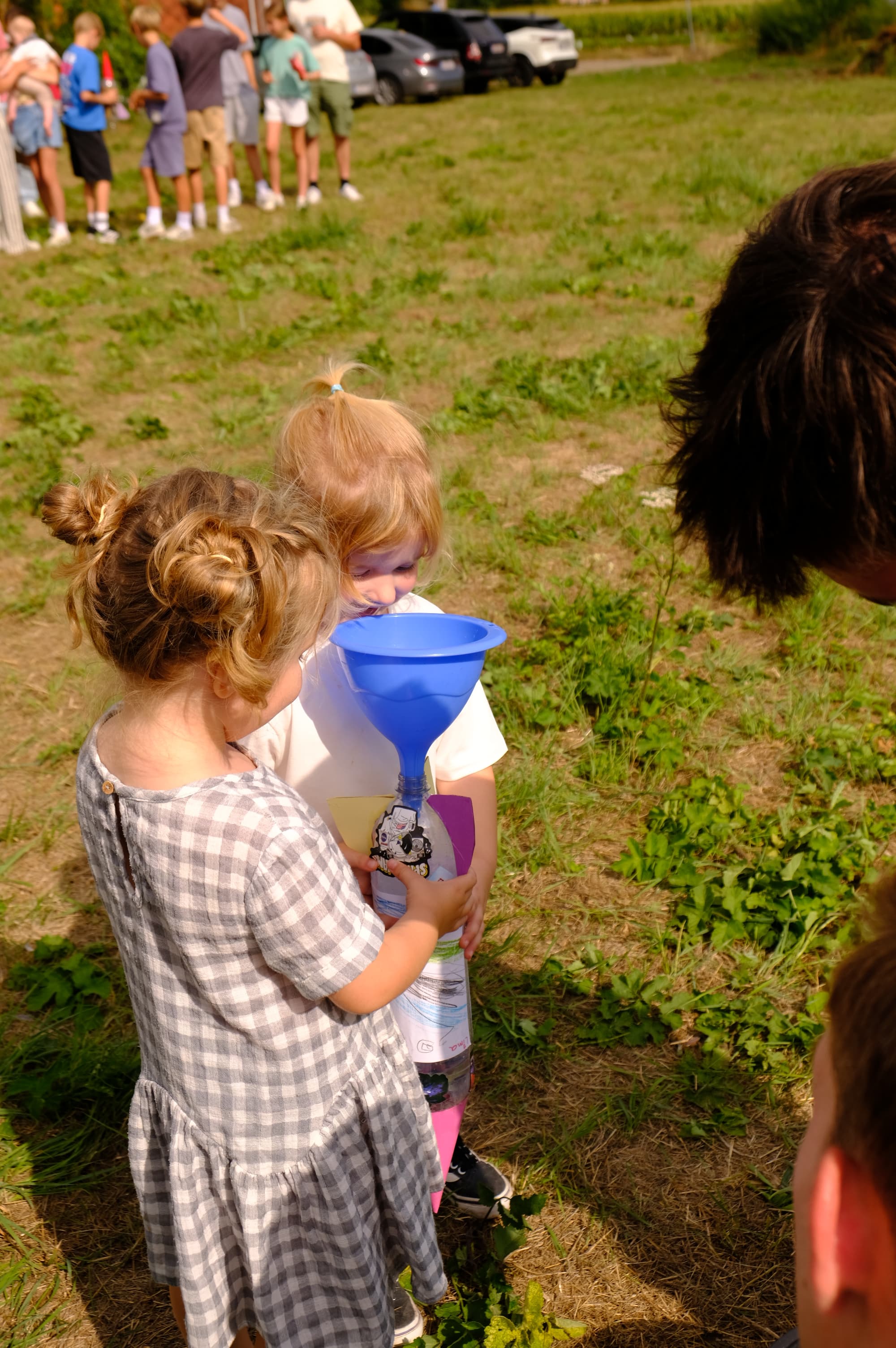 Helping a young builder load her rocket onto the launcher.